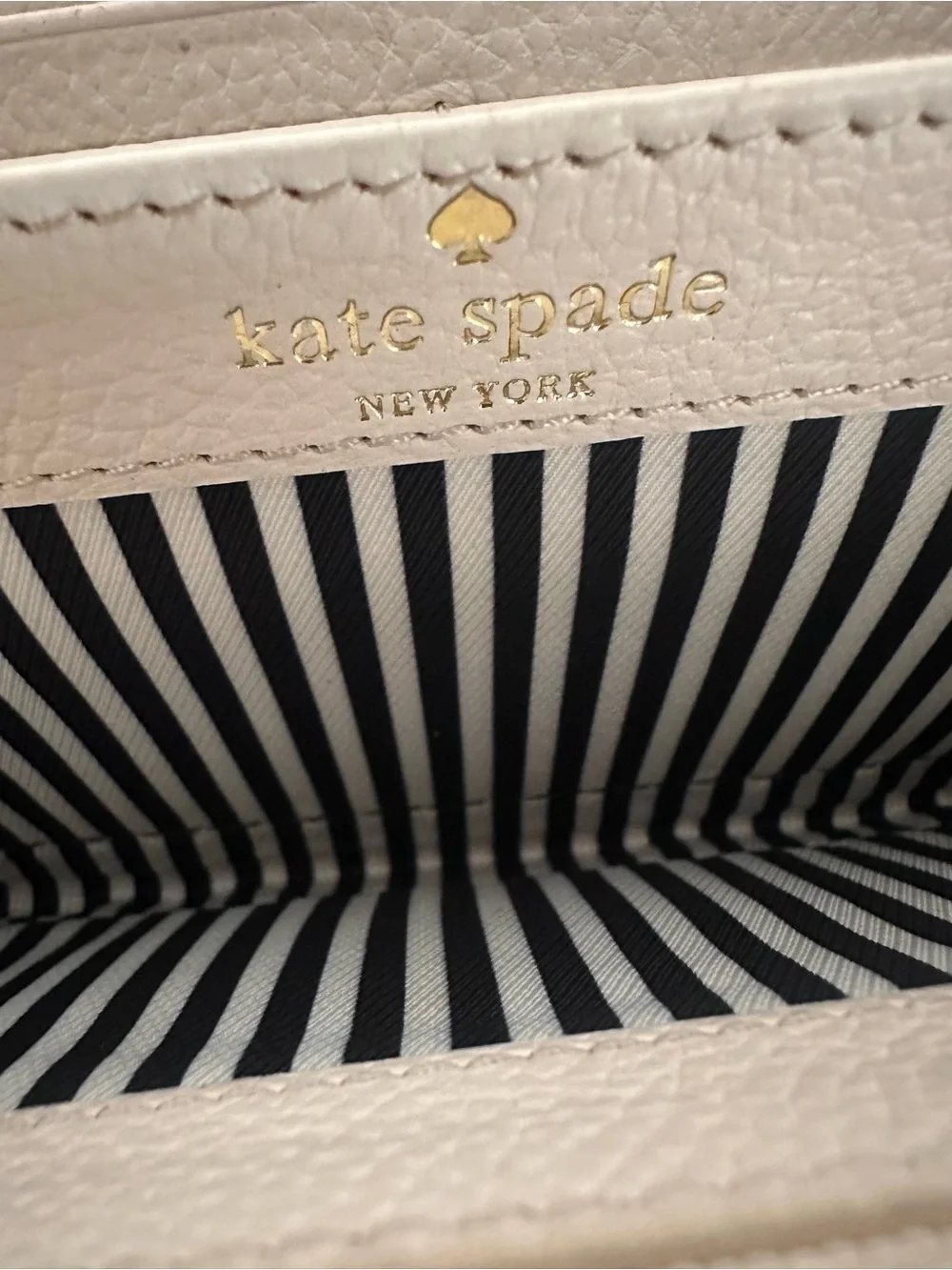 kate spade cream zip-around wallet with black bow detail